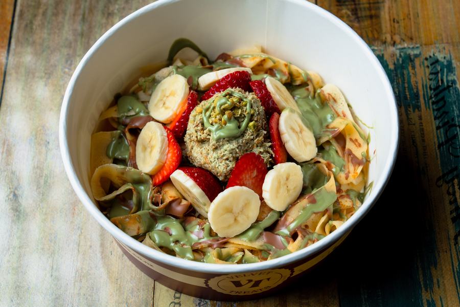 Fettuccine crepe ribbons with banana, strawberry, pistachio kunafa and chocolate drizzle